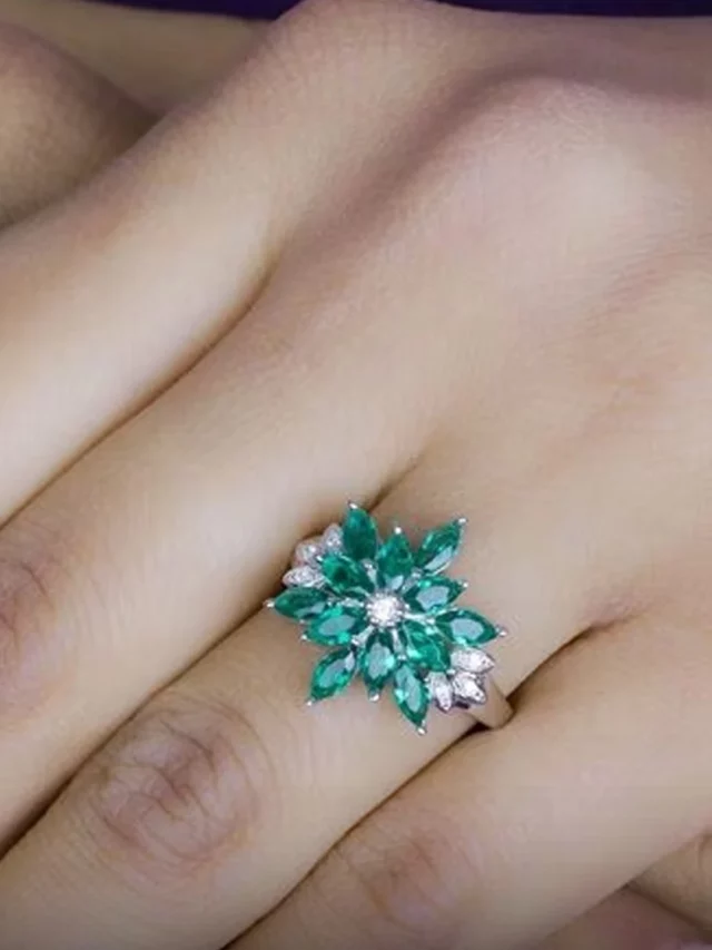 Girl wearing a floral emerald ring