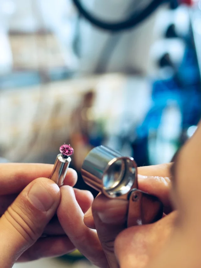 gemologist examining pink sapphire